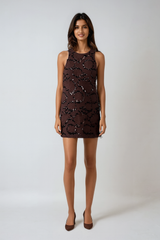 Woman wearing a brown mini dress on a white background